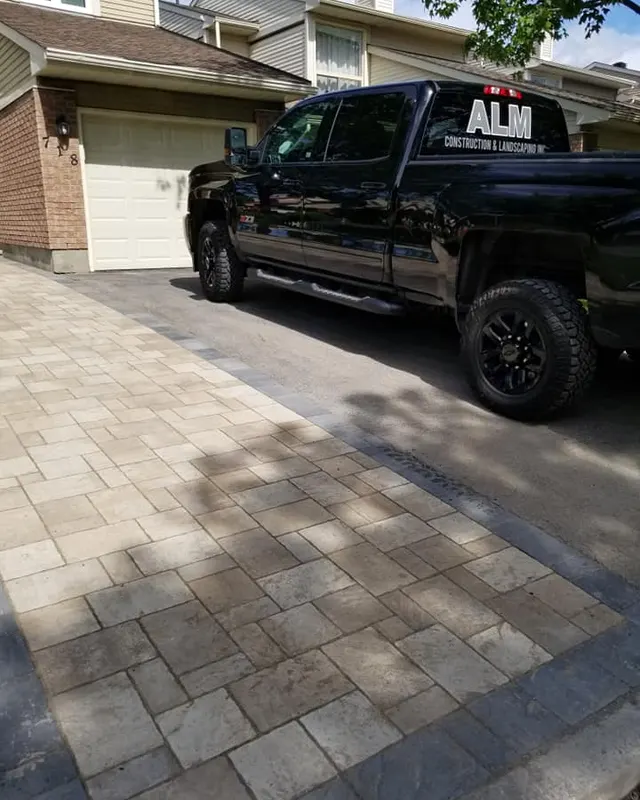 ALM Construction crew installing an interlock patio on an Ottawa job site