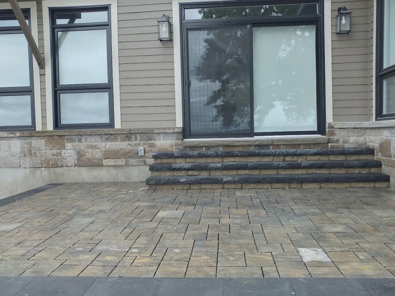 Custom interlocking patio with stone-veneer house, hardscaping by ALM Construction Ottawa